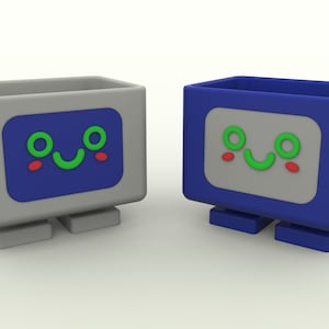 May include: Two small gray and blue robot-shaped containers with smiling faces. The containers have a rectangular shape with rounded edges and small legs. The containers are made of plastic and have a smooth surface.