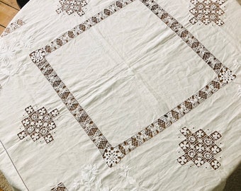 A white tablecloth, vintage, embroidered, large, rectangular.