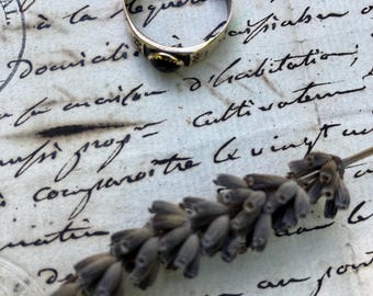 An antique ring, 19/20th century, stamped 333 for 8 karat gold German, oval cut garnet, UK size M, US 6, repair to band