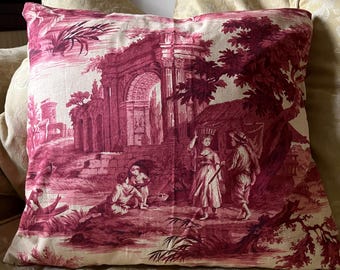 A rectangular toile de jouy cushion, red and cream, classical ruins, figures, red patterned cotton back, feather insert.