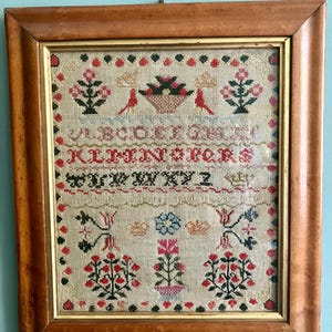 A cross stitch sampler, Scottish, antique, framed, Elizabeth Myers aged 11, 1820.  bright colours, birds, flower basket, crowns.