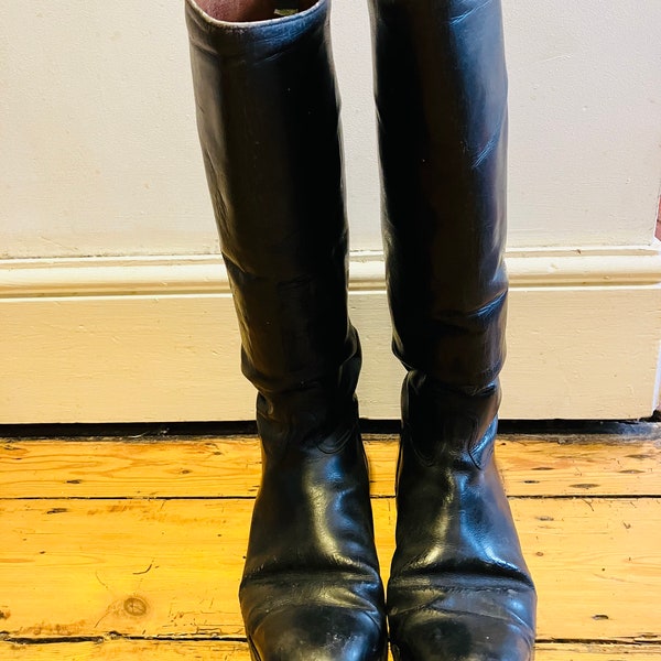 A pair of vintage Riding Boots, long, black leather, 7F on the sole.