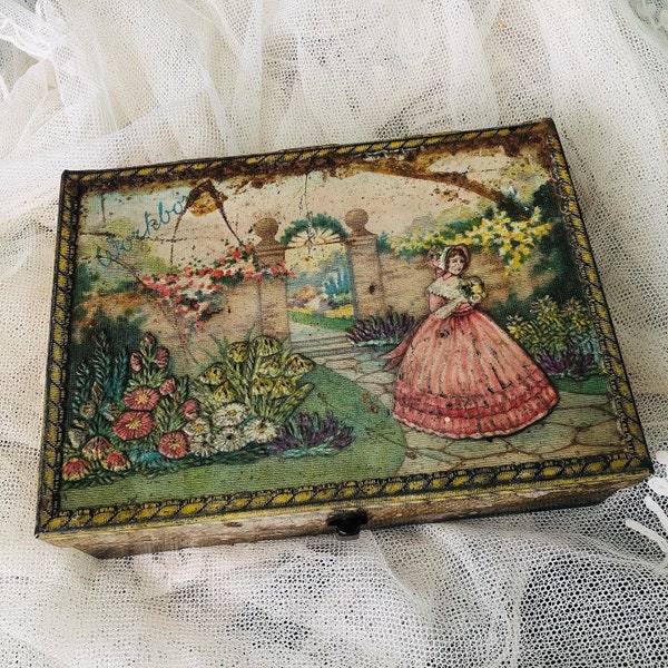 A vintage work box, tin, crinoline lady