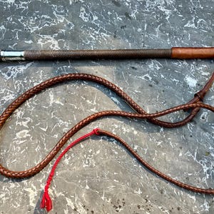 A Swaine Riding Crop/whip with lash, silver collar, antler handle, Swaine button.