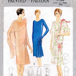 May include: A vintage sewing pattern for a dress, featuring three different styles. The pattern is labeled "5270 Size 36" and "45 cents". The pattern is for ladies' and misses' dresses.