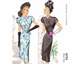 May include: Vintage sewing pattern for a wrap dress. The pattern is for Misses' sizes and is printed on paper. The pattern shows two women wearing the dress, one in a black dress and one in a blue and white floral dress. The pattern number is 6724 and the price is 65c.