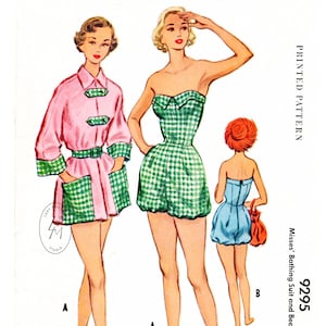 May include: A vintage sewing pattern for a bathing suit and beach coat. The pattern shows three women wearing the different styles. The bathing suit is a green and white gingham print with a strapless top and shorts. The beach coat is pink with green trim and pockets.