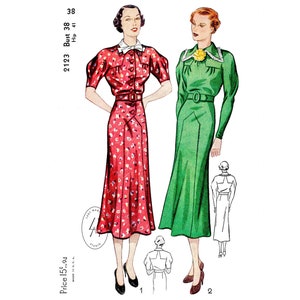 May include: Two women's dresses, one red with white floral print and one green, both with a fitted bodice and a full skirt. The dresses are shown on mannequins with the pattern number 2123, bust 38, hip 41, and price 15¢.