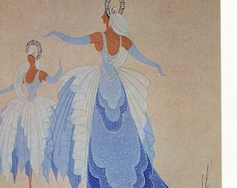 May include: Two women in blue and white dresses with intricate designs. The woman in the front has a long, flowing blue dress with a pattern of small white dots. The woman in the back has a white dress with a blue trim. Both women are wearing headbands with jewels.