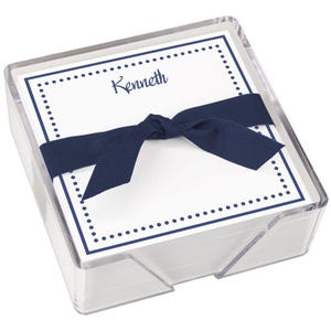 May include: A clear plastic box filled with white note cards with a navy blue border of dots. The box is tied with a navy blue ribbon and the top card has the name "Kenneth" written in navy blue.