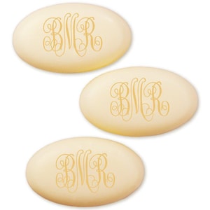 May include: Three oval-shaped soaps with a creamy ivory hue. Each soap features the gold-colored monogram "BNR" in an elegant, swirling script. The soaps are arranged against a white background.