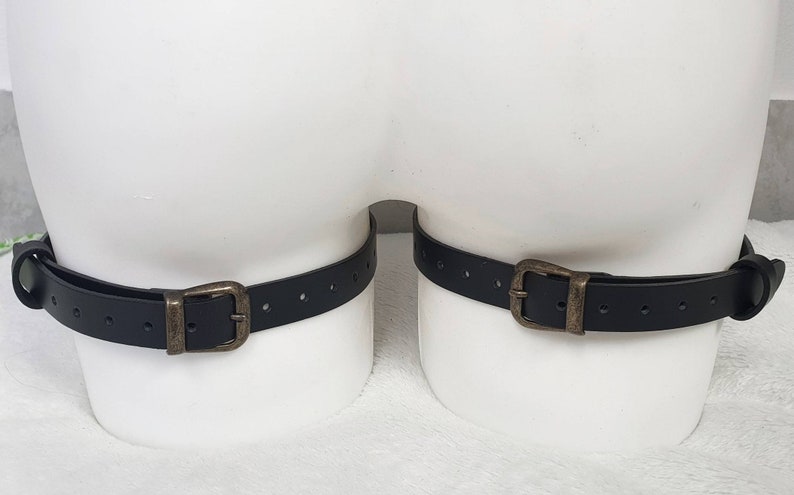 Puede incluir: Dos correas de cuero negro con hebillas de lat&oacute;n. Las correas son ajustables y tienen varios agujeros para diferentes tama&ntilde;os.