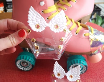 Transparent PVC Roller Skate Toe Guards with white or gold wings.