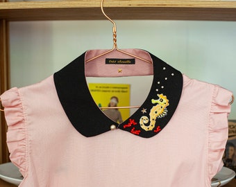 Cotton Peter Pan collar featuring seahorse patch, glass beads and star. With golden button on the front.