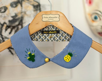 Dusty blue Peter Pan collar featuring acrylic cactus and pineapple beads. With golden button.