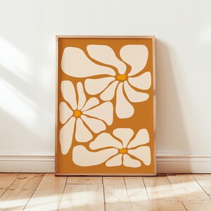 May include: Abstract art print featuring three stylized white flowers with yellow centers on a mustard yellow background.