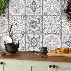 May include: A kitchen backsplash featuring patterned tiles in shades of grey, brown and white. The tiles have intricate geometric patterns and floral motifs.