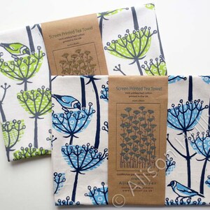 Peut inclure: Deux torchons de cuisine avec un motif floral repr&eacute;sentant des fleurs bleues et vertes et des oiseaux. Les torchons sont en coton non blanchi 100% et sont imprim&eacute;s &agrave; l'&eacute;cran au Royaume-Uni. Le texte sur l'&eacute;tiquette indique "Screen Printed Tea Towel 100% unbleached cotton printed in the UK"