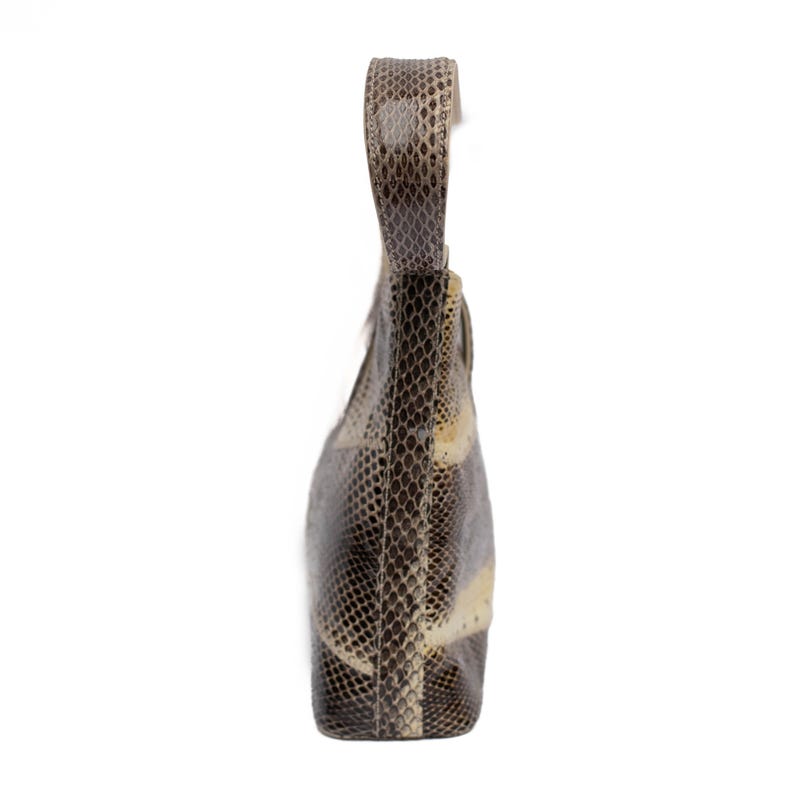 May include: A snakeskin-patterned handbag with a single handle. The bag features a mix of brown, gray, and cream tones, creating a textured appearance. The handle is a continuation of the bag's material, and the bag is set against a white background.