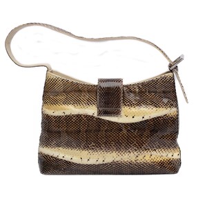 May include: A snakeskin-patterned handbag with a cream-colored strap and a rectangular flap closure. The bag features horizontal bands of brown, tan, and cream colors. The strap is attached to the bag with a silver-colored metal buckle.