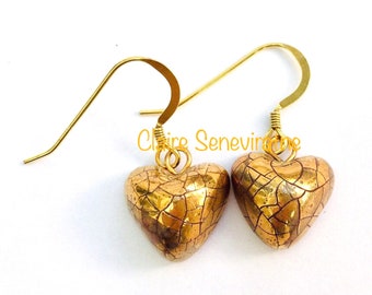 Gold heart ceramic drop earrings.