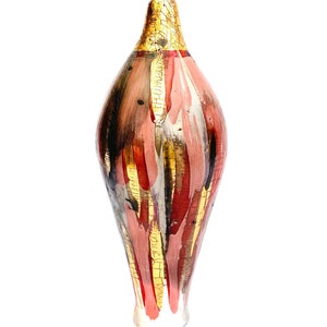May include: A tall, slender ceramic vase with a unique, abstract design. The vase is painted in shades of pink, red, black, and gold, with a crackled glaze effect. The vase has a rounded base and a narrow neck.