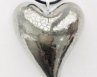 Large silver heart pendant with an adjustable cotton cord.