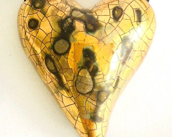 Large gold heart pendant on an adjustable cotton cord by artist Claire Seneviratne. Special gift for partner or Mom.