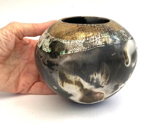 A smoke-fired ceramic pot.