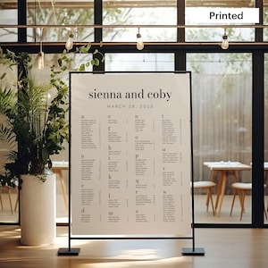 May include: A black and white wedding seating chart with the names "sienna and coby" and the date "MARCH 28, 2025" at the top. The chart is divided into alphabetical sections with guest names and table numbers listed.