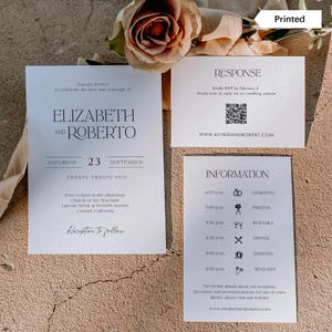 May include: Wedding invitation suite with a minimalist design. The invitation features the names Elizabeth and Roberto, the date September 23rd, and the location Carmel, California. The response card includes a QR code and the website www.astridandrobert.com. The information card lists the wedding day schedule with times and icons for each event.