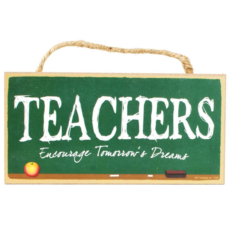May include: A green chalkboard sign with the text "TEACHERS Encourage Tomorrow's Dreams". The sign has a red apple and a white chalk eraser on it.