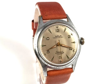 ULTRA zeldzaam vintage Duits herenpolshorloge genaamd "WELA ANKER". Anker-horloge. Vintage herenhorloge, wordt geleverd met gloednieuwe leren band!