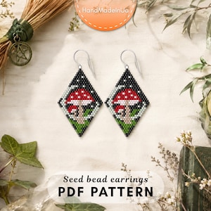 May include: Diamond-shaped seed bead earrings featuring a red and white mushroom design on a black background with green foliage at the base. The earrings hang from silver-toned metal hooks. The text Seed bead earrings PDF PATTERN is visible.