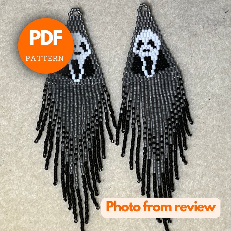 May include: A pair of black and gray beaded earrings with a white ghost face design. The earrings are long and have a fringe of beads. The text "PDF PATTERN" is visible in the image.