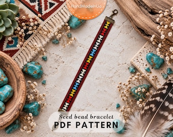 May include: A long, narrow seed bead bracelet featuring a geometric pattern in red, white, yellow, and blue. The bracelet is finished with bronze-colored metal end caps and a lobster claw clasp. The text Seed bead bracelet PDF PATTERN is visible.