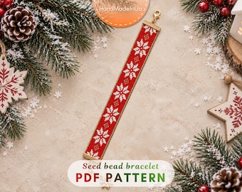 May include: A rectangular seed bead bracelet featuring a repeating pattern of white snowflakes on a red background with small gold accents. The bracelet is finished with a gold-toned metal clasp at one end and a matching gold-toned metal bar at the other.