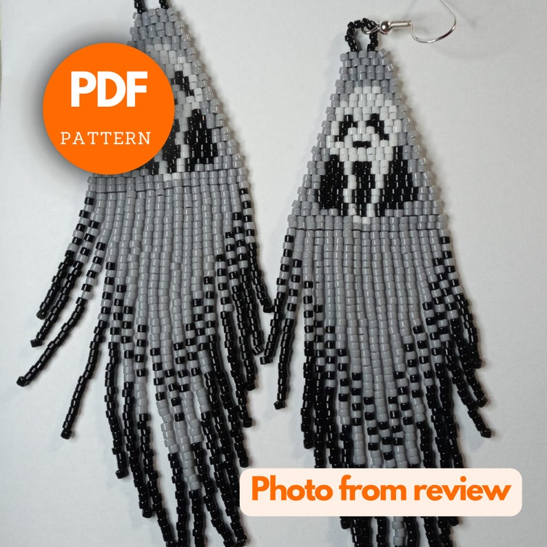 May include: A pair of gray and black beaded earrings with a white ghost face design. The earrings are long and dangle. The image includes the text "PDF PATTERN".