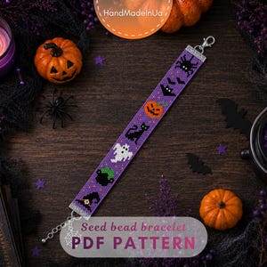 May include: A purple seed bead bracelet featuring a repeating Halloween-themed pattern of a spider, bat, pumpkin, black cat, ghost, cauldron, and witch hat. The bracelet includes a silver-toned metal lobster clasp and an adjustable chain extension.