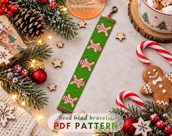 May include: A green seed bead bracelet featuring a repeating pattern of small gingerbread men. The bracelet has a bronze-toned metal clasp at one end and a matching metal end bar at the other. The design is flat and rectangular in shape.