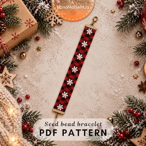 May include: A seed bead bracelet featuring a red and black buffalo plaid pattern with white snowflake motifs. The bracelet has gold-toned metal end caps and a lobster claw clasp. The text "Seed bead bracelet PDF PATTERN" is visible.