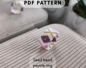 May include: A beaded ring with a floral design. The ring is white with pink and purple flower accents and gold-colored details. The text "PDF PATTERN" is at the top, and "Seed bead peyote ring" is at the bottom.