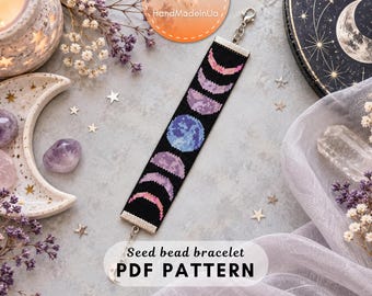 May include: A rectangular seed bead bracelet featuring a black background with a colorful lunar cycle pattern. The design displays various moon phases in shades of pink, purple, and blue. It includes silver-toned metal end bars and a lobster clasp.