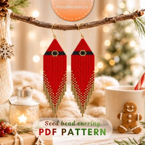 May include: A pair of long, pointed seed bead earrings featuring a red Santa suit design with a black belt and gold buckle detail. The lower portion of the earrings transitions into a gold beaded fringe. The text Seed bead earring PDF PATTERN is visible.
