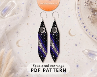 May include: A pair of long, diamond-shaped seed bead earrings featuring a celestial design with a crescent moon at the top, a black background, and a diagonal gradient of blue, purple, and white beads. The text reads Seed bead earrings PDF PATTERN.