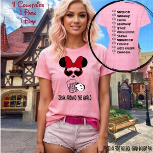 May include: Pink t-shirt with a Mickey Mouse design wearing sunglasses and holding a beer mug. The text "Drink Around the World" is printed below the design. The shirt also has a list of 11 countries printed on the right side. The text "Printed on front and back - Shown on light pink" is printed at the bottom of the image.