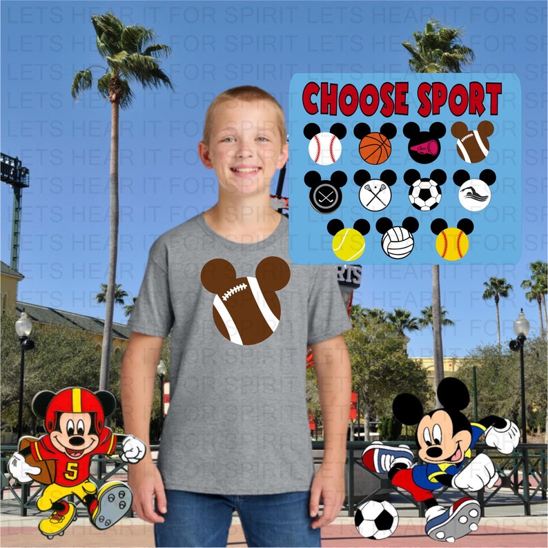 May include: A gray t-shirt featuring a football design in the shape of Mickey Mouse ears. The image includes a sign that says "CHOOSE SPORT" with various sports icons. Two Mickey Mouse figures are also present, one in a football uniform and the other playing soccer.