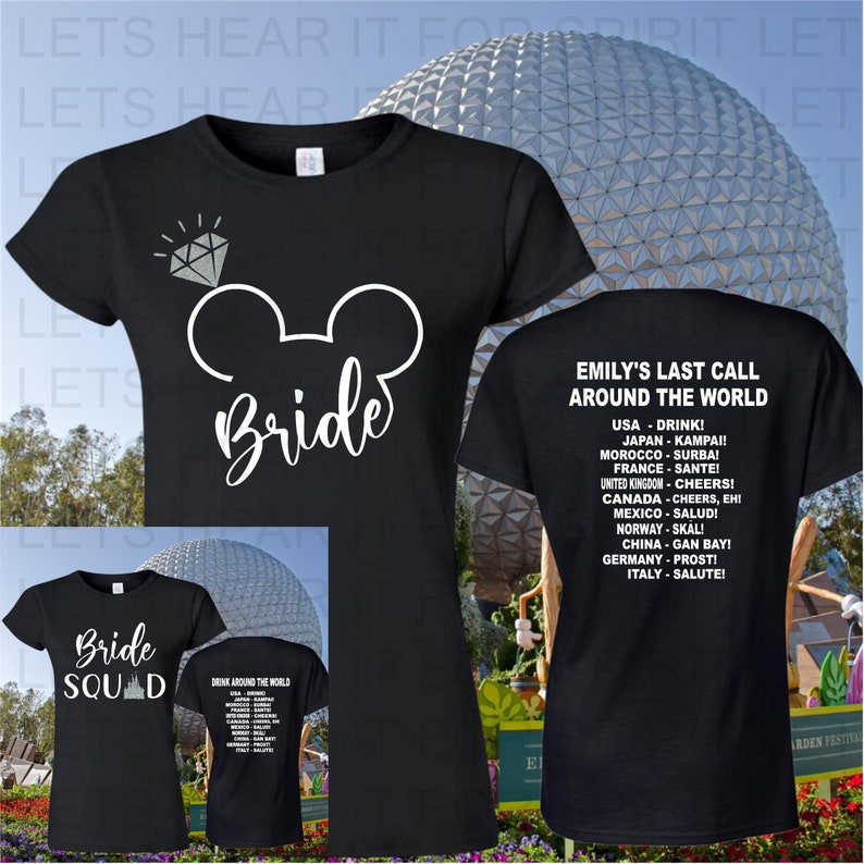 May include: Two black t-shirts with white text. The front of the first shirt has a white Mickey Mouse head with a diamond above it and the word "Bride". The back of the second shirt has the text "Emily's Last Call Around the World" and a list of countries with their respective drinking toasts.