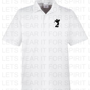 May include: White polo shirt with a black silhouette of Mickey Mouse playing golf on the left chest. The shirt has the text "TEAM" in a small black rectangle on the collar.