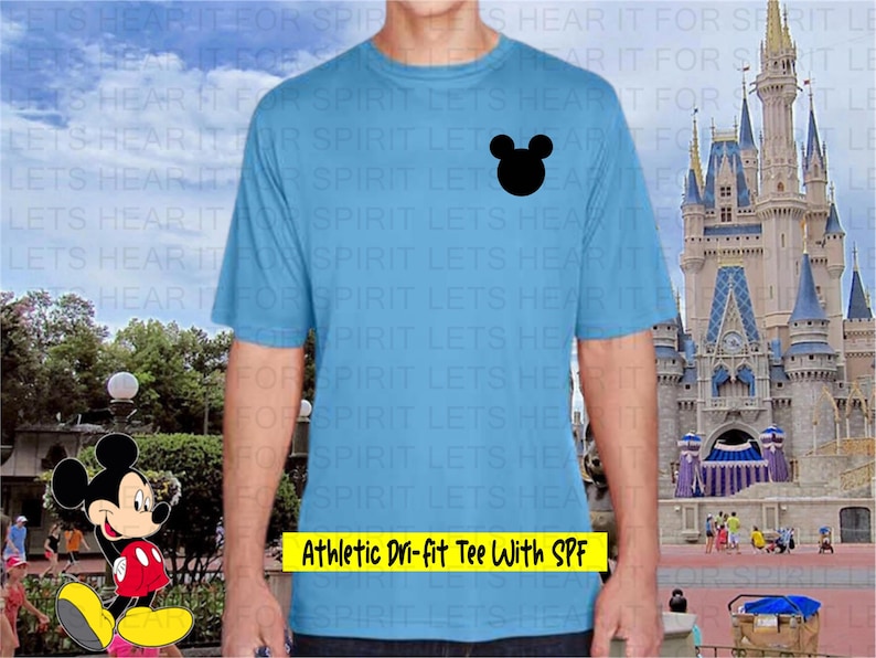 May include: Light blue athletic tee shirt with a black Mickey Mouse head graphic. The shirt has the text "Athletic Dri-fit Tee With SPF" in a yellow rectangle. The shirt is made of a moisture-wicking material.